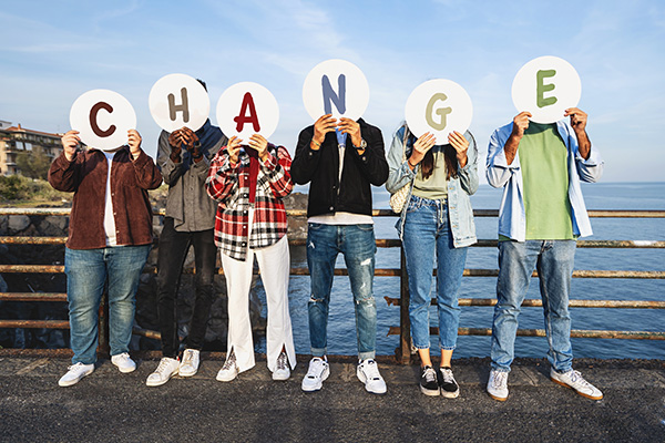 Youth Advocating for Change: Multiracial young people cover faces with 