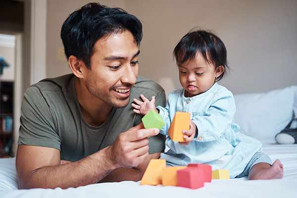 Dad with infant playing with blocks