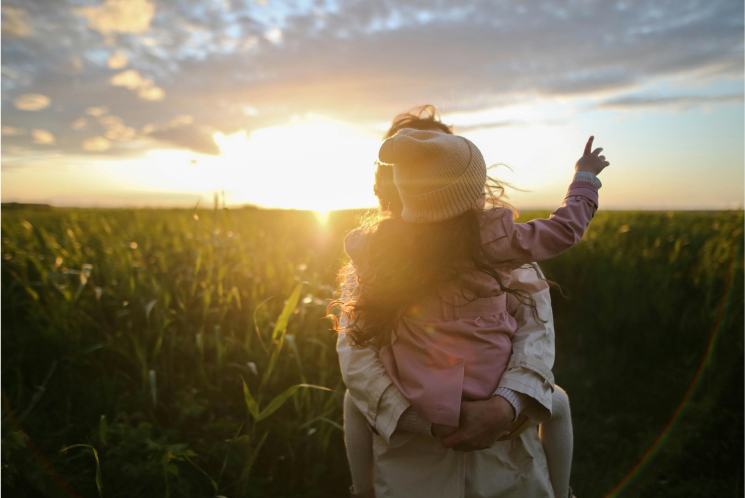 Mother and child in sunset fields