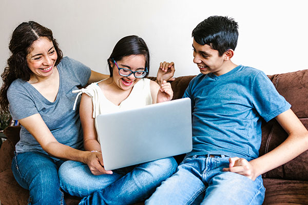 a family looking at a laptop together