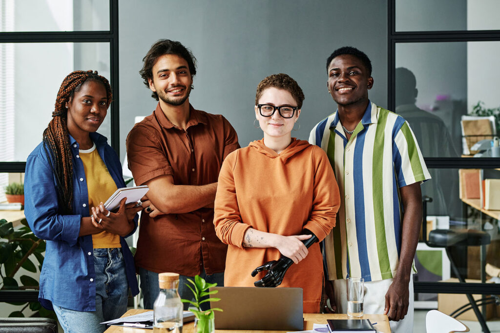 a group of young professionals standing behind a desk