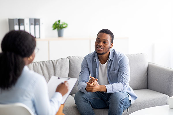 A young man talking to a psychologist