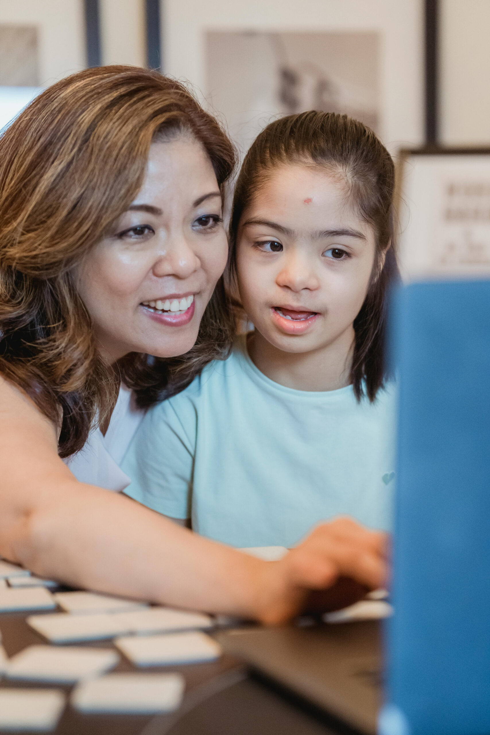 a mom with her daughter looking at a computer