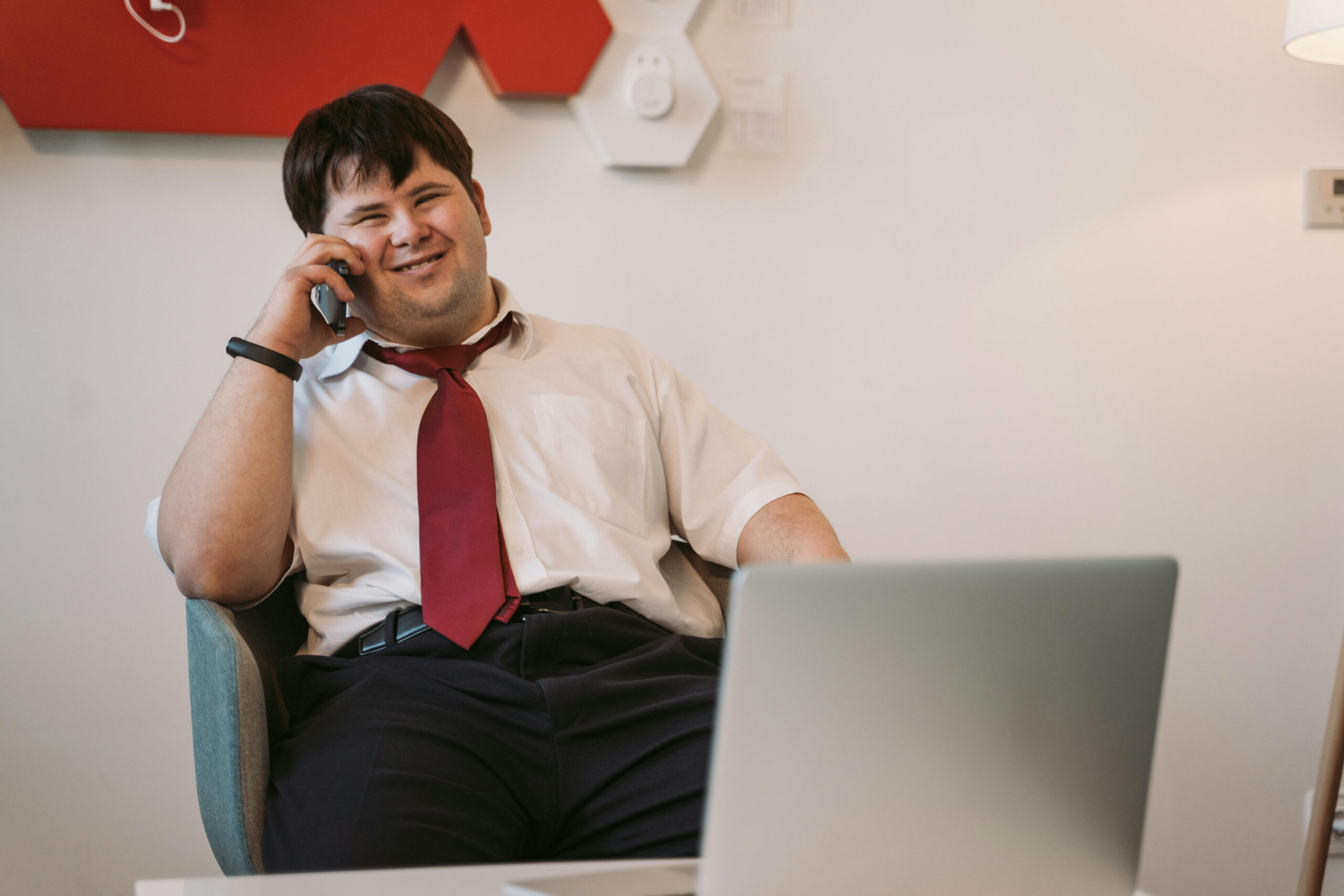 an adult male on the phone smiling