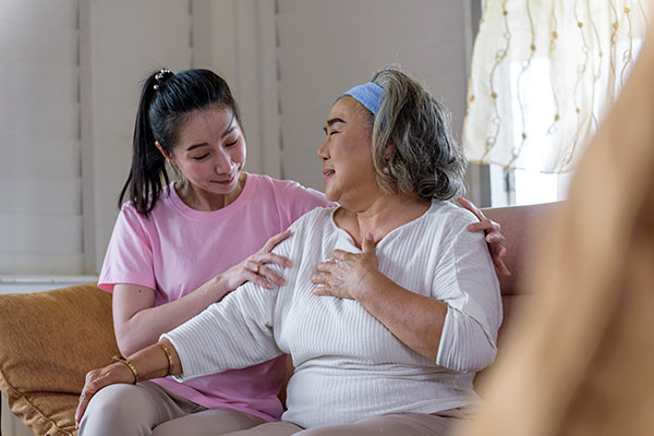 a young woman hugging an elderly woman