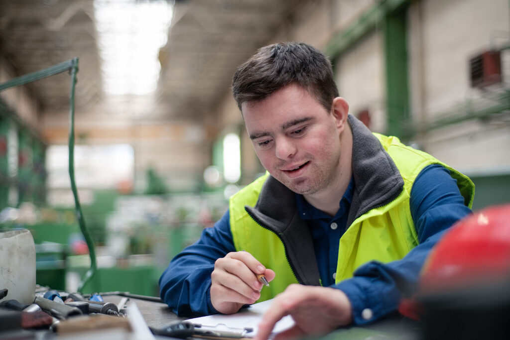 a man with down syndrome working in the industry